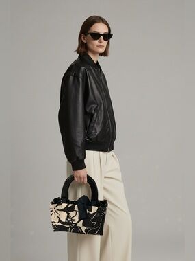 NWOT Never used! 
Beautiful bag 
Black/white design 
Black wooden handles.